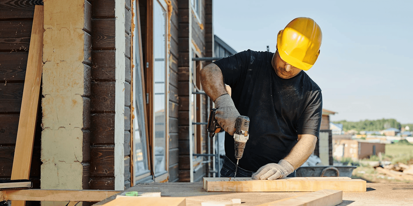 Image of a person drilling into a wooden block